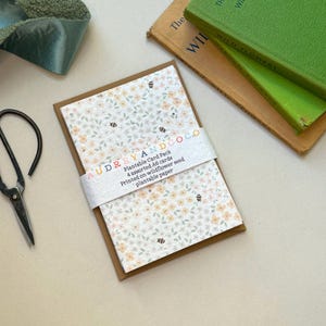 May include: A pack of plantable greeting cards with a floral design and the text "AUDREYANDCOCO Plantable Card Pack 4 assorted A6 cards Printed on wildflower seed plantable paper" on the front.