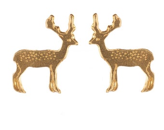 May include: A pair of gold-tone deer stud earrings. The deer are facing to the right and have a textured surface.