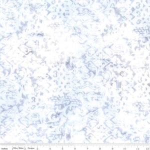 May include: White and light blue fabric with a repeating pattern of stylized floral and geometric shapes. The fabric has a watercolor effect, with a ruler along the bottom showing inches.