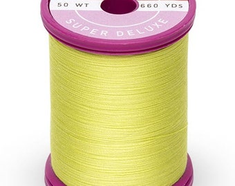 May include: A spool of yellow cotton thread with a pink label that reads "Cotton + Steel Super Deluxe 50 Wt 660 Yds."