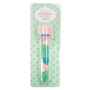May include: A clear plastic tube filled with colorful point protectors. The tube has a pink lid and is labeled "100% Cute Point Protectors by Lori Holt of Bee in my Bonnet".