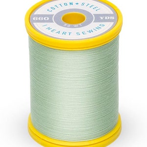 May include: A spool of mint green thread with a yellow top and base. The top of the spool has text that reads "Cotton + Steel" and "I Heart Sewing". The thread is 660 yards, 50 wt.