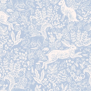 May include: A light blue and white pattern featuring rabbits, squirrels, flowers, and foliage. The design has a vintage, hand-drawn aesthetic, with the animals and plants in white against the blue background. The overall theme is nature and woodland.