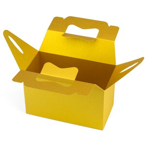 May include: A gold cardboard box with a handle, open and ready to be filled. The box is made of sturdy cardboard and has a smooth finish.