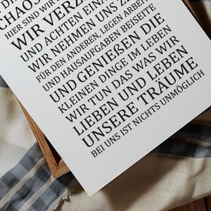 May include: A white poster with black text that reads "D Chaos Here We Are We Turn And Pay Attention To Each Other, We Take On Ourselves, We Put Work And Homework Aside And Enjoy The Little Things In Life, We Do What We Love And Live Our Dreams, With Us Nothing Is Impossible."