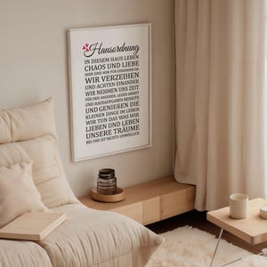 May include: A black and white framed print with the text "Hausordnung" in a decorative font. The text reads "In diesem Haus leben Chaos und Liebe. Hier sind wir f&uuml;r einander da. Wir verzeihen und achten einander. Wir nehmen uns Zeit f&uuml;r den anderen, legen Arbeit und Hausaufgaben beiseite und genie&szlig;en die kleinen Dinge im Leben. Wir tun das was wir lieben und leben unsere Tr&auml;ume. Bei uns ist nichts unm&ouml;glich."