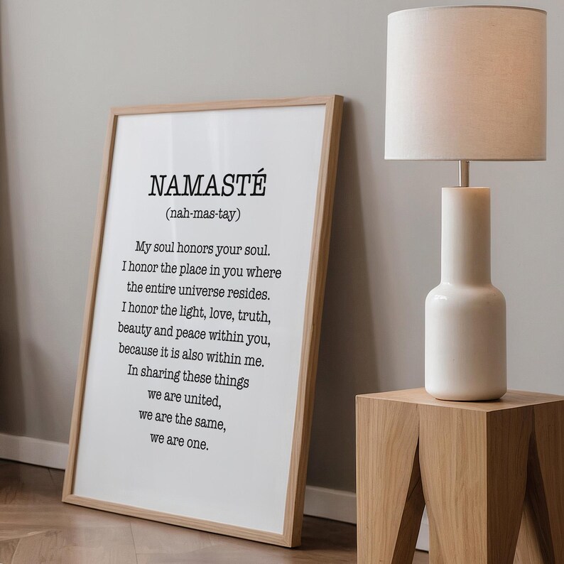 May include: A framed print with the word "Namaste" in large, bold letters and the definition of the word in smaller text below. The definition is "(nah-mas-tay) My soul honors your soul. I honor the place in you where the entire universe resides. I honor the light, love, truth, beauty and peace within you, because it is also within me. In sharing these things we are united, we are the same, we are one."