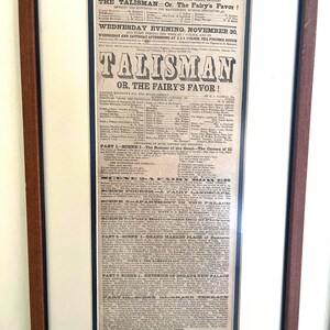 May include: A framed vintage theater playbill for the Boston Museum production of the oriental fairy drama Talisman, or, The Fairy's Favor. The black and white poster features detailed typography listing the cast, scenes, and performance schedule.