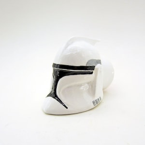 May include: White plastic helmet with black markings, resembling a Star Wars Clone Trooper helmet.