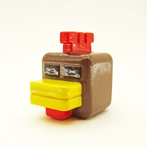 May include: A brown and yellow chicken figurine with a red comb. The figurine is made of wood and has a pixelated design.