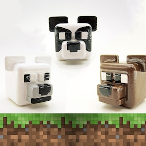 May include: Three 3D printed animal heads, a panda, a polar bear, and a brown bear. The animal heads are white, black, and brown. The animal heads are all facing forward.