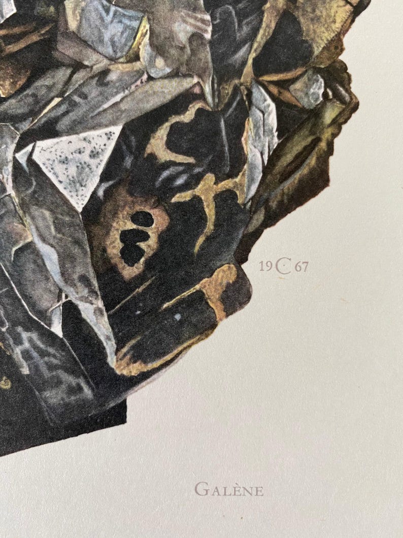 May include: A close-up of a black and gold mineral specimen with a textured surface. The specimen is labeled "19 C 67" and "GALLENE".