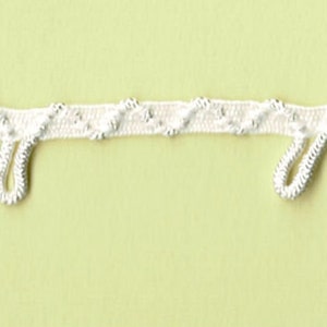 May include: White trim with a decorative pattern and loops for curtains or drapery.
