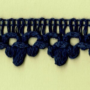 May include: Navy blue crocheted trim with a scalloped edge and small, round, decorative knots.