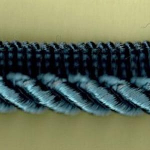 May include: Blue and gray braided trim with a textured, rope-like design. This trim is perfect for adding a touch of elegance to any project.