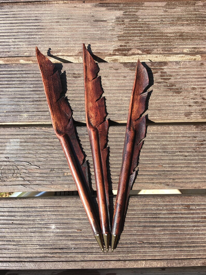 Handcrafted feather-shaped genuine leather pen, matching accessory for our handmade leather journals.