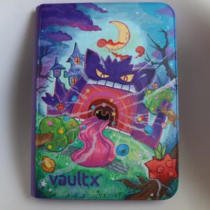 May include: A rectangular purple binder featuring a vibrant illustration of a purple creature with a long pink tongue, a crescent moon, and a spooky castle. The cover displays the text vaultx in the bottom left corner against a grassy landscape.