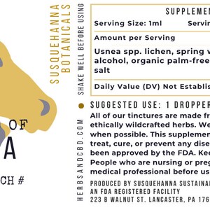 May include: A product label for Susquehanna Botanicals Tincture of Usnea. The label features a stylized illustration of two horse heads in yellow and gray. The label includes supplement facts and usage instructions.
