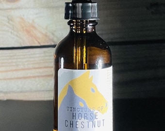 May include: A brown glass bottle with a dropper top and a label that reads "Tincture of Horse Chestnut" with a yellow horse illustration. The bottle is sitting on a wooden surface.