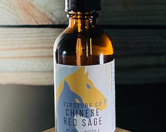 May include: A brown glass bottle with a dropper top, labeled "Tincture of Chinese Red Sage" with a horse illustration. The bottle is sitting on a wooden surface.