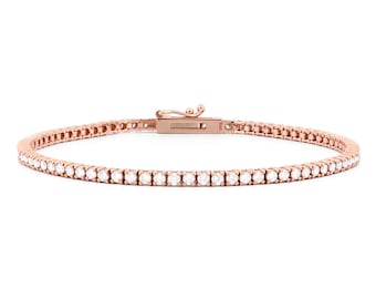 May include: Rose gold tennis bracelet with a row of round, clear gemstones. The bracelet features a secure clasp and is set against a white background. The jewelry is a delicate accessory.