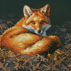 May include: A cross-stitch depiction of a red fox resting among autumn leaves. The fox has a white chest and muzzle, with orange and brown fur. The background is a dark green, and the leaves are shades of brown and gold.