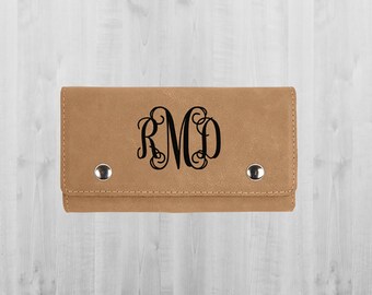 May include: A brown leather wallet with a monogrammed design. The monogram is in black and reads "RMD".