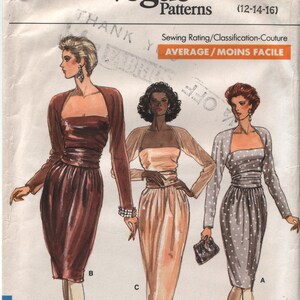 May include: Vogue Patterns sewing pattern number 7098 for a dress with a fitted bodice and a skirt. The pattern includes three different styles: a brown dress with a fitted skirt, a beige dress with a flowing skirt, and a gray dress with a polka dot pattern. The pattern is for sizes 12-14-16.