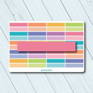 May include: A sticker sheet featuring a grid of pastel-coloured rectangular labels in shades of pink, orange, teal, purple, and green. A large pink rectangle overlays the centre. The text "plannermint" is at the bottom.