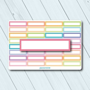 May include: A sticker sheet with rectangular boxes in various colors, including pink, orange, green, and blue. The boxes have white interiors and are arranged in rows and columns. The text "plannermint" is at the bottom.