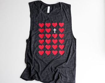May include: A dark gray sleeveless tank top with a pattern of red hearts and a white cross in the center.