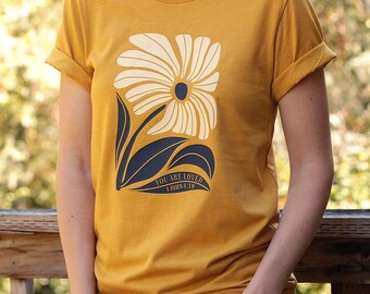 You Are Loved Christian Shirt for Women and Teen Girls in a unisex style with a Faith-Based Flower and 1 John 4:19 Bible Verse theme