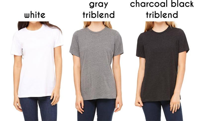 May include: Three t-shirts in different colors: white, gray triblend, and charcoal black triblend. The shirts are all crew neck and short-sleeved.