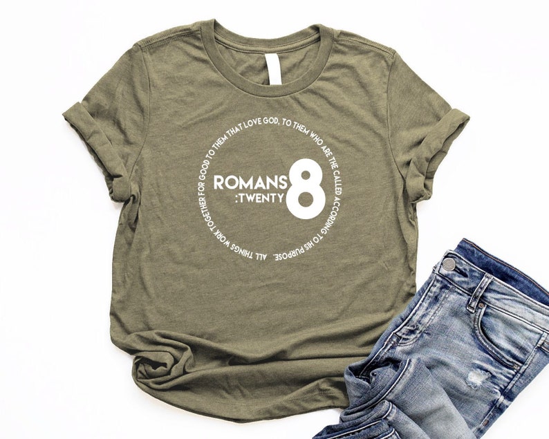 May include: A green t-shirt with a white circle graphic that says "Romans 8:Twenty" and "All things work together for good to them that love God. To them who are the called according to His purpose."