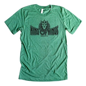 May include: Green t-shirt with a black graphic of a lion with a crown and the text "King of Kings" with the text "Revelation 19:16" underneath.