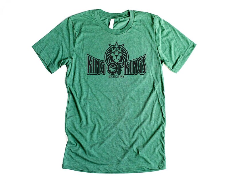 May include: Green t-shirt with a black graphic of a lion with a crown and the text "King of Kings" with the text "Revelation 19:16" underneath.