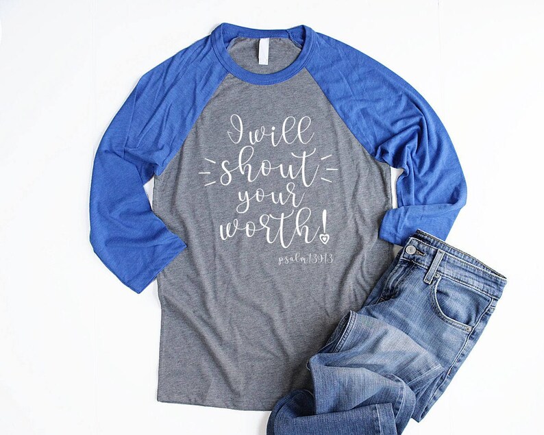 May include: A gray and royal blue baseball tee shirt with the text "I will shout your worth! Psalm 139:13" printed in white on the front.