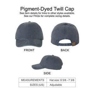 May include: A pigment-dyed twill cap in a dark blue color. The cap has an adjustable strap and is shown from the front, back, and side. Hat size: 6 5/8 - 7 3/8.