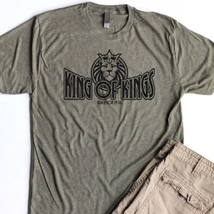 May include: A green t-shirt with a black graphic of a lion wearing a crown and the text "King of Kings" with the scripture reference "Revelation 19:16".