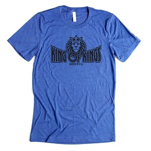 May include: A royal blue t-shirt with a black graphic of a lion wearing a crown and the text "King of Kings Revelation 19:16".