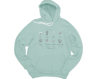 May include: A light blue hooded sweatshirt with a floral design and the text "Whatever is true, noble, right, pure, lovely, admirable, excellent, praiseworthy - think about such things. Philippians 4:8".