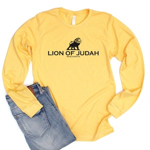 May include: A yellow long-sleeved t-shirt with a black lion graphic and the text "Lion of Judah" and "Revelation 5:5".