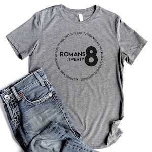 May include: Gray t-shirt with a black circle graphic that says "Romans 8:Twenty" and "All things work together for good to them that love God, to them who are the called according to His purpose."