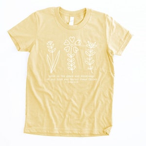 May include: A yellow t-shirt with a white floral design and the text "grow in the grace and knowledge of our Lord and Savior Jesus Christ 2 Peter 3:18".