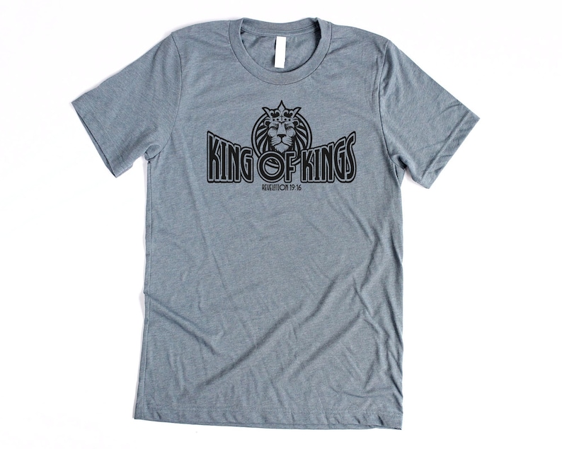 May include: A heather gray t-shirt with a black graphic of a lion wearing a crown and the text "King of Kings" with the scripture reference "Revelation 19:16".