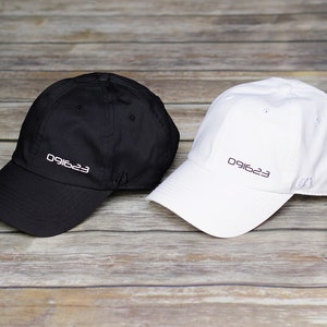 May include: Two baseball caps, one black and one white, with the number "091623" embroidered on the front of each.
