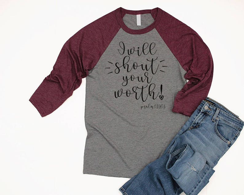 May include: A gray and burgundy raglan t-shirt with the text "I will shout your worth! Psalm 139:13" printed on the front.