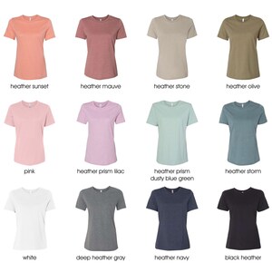 May include: A selection of 12 t-shirts in various colors and styles, including heather sunset, heather mauve, heather stone, heather olive, pink, heather prism lilac, heather prism dusty blue green, heather storm, white, deep heather gray, heather navy, and black heather.