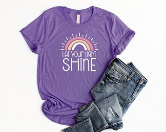 May include: Purple t-shirt with a rainbow and the text "Let your light shine" printed on the front.