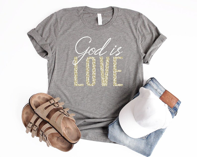 May include: A gray t-shirt with the text "God is Love" in white and gold leopard print lettering.